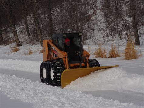 tracked skid steer pushing snow|over tire skid steer tracks.